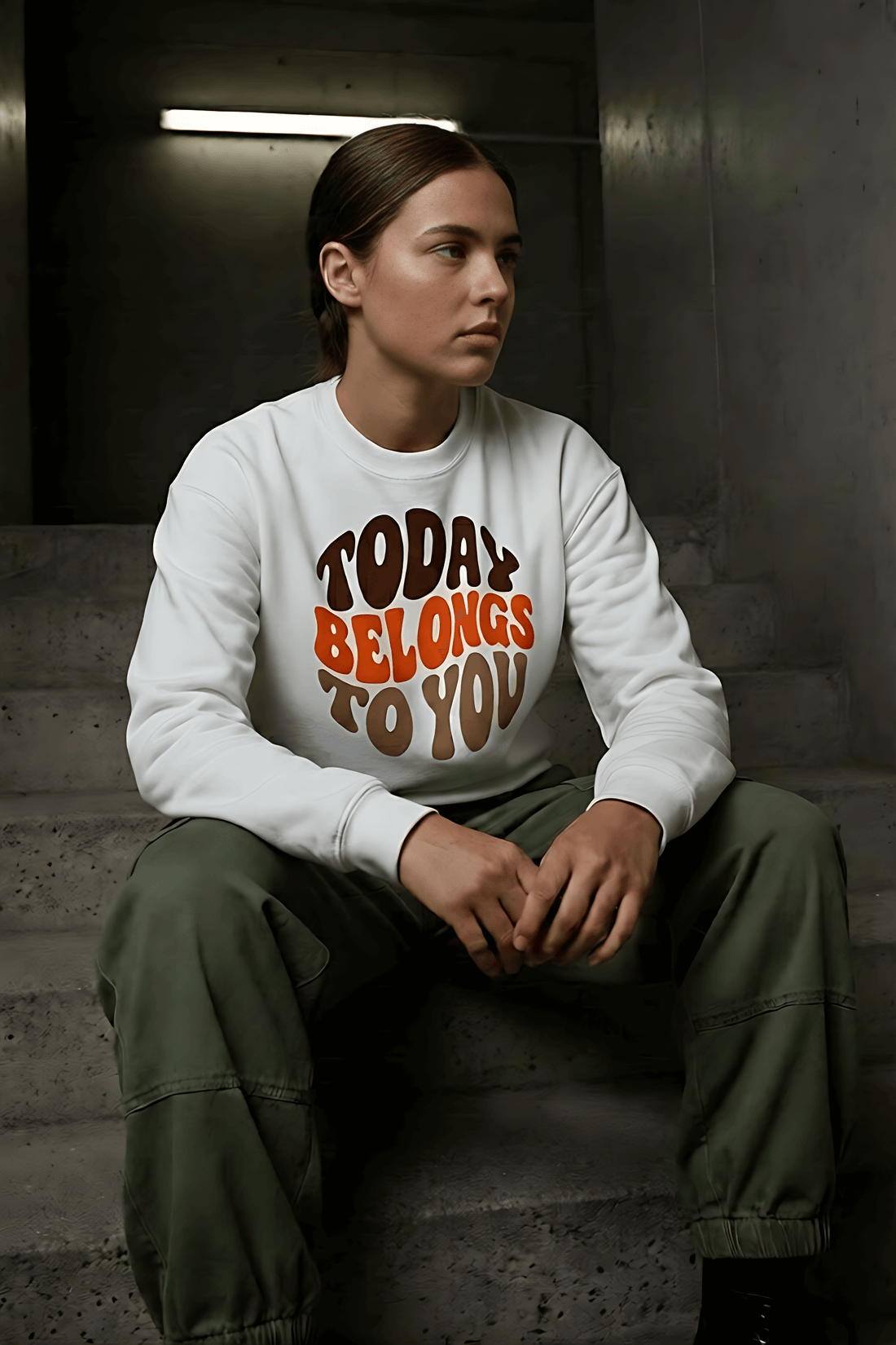 Woman wearing a white "Today Belongs To You" graphic sweatshirt and olive green cargo pants-AWONDERS