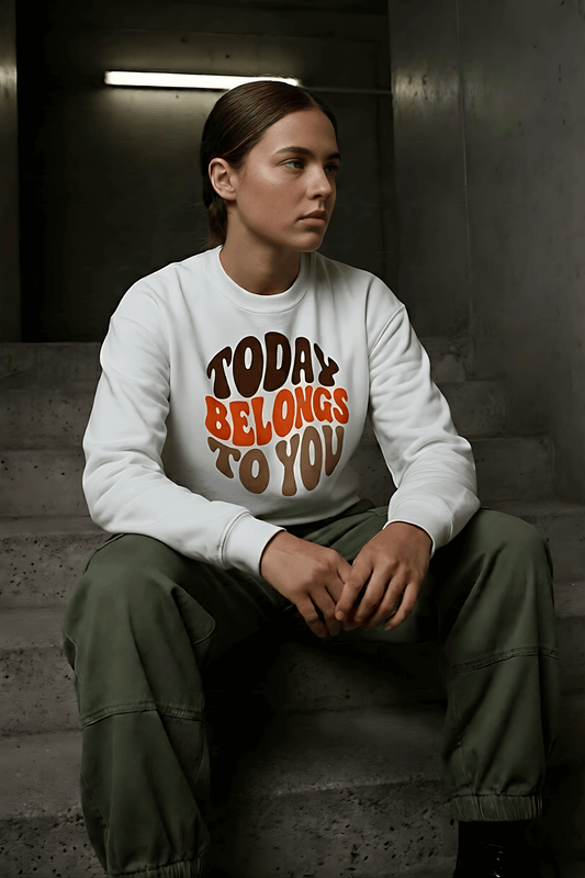 Woman wearing a white "Today Belongs To You" graphic sweatshirt and olive green cargo pants-AWONDERS